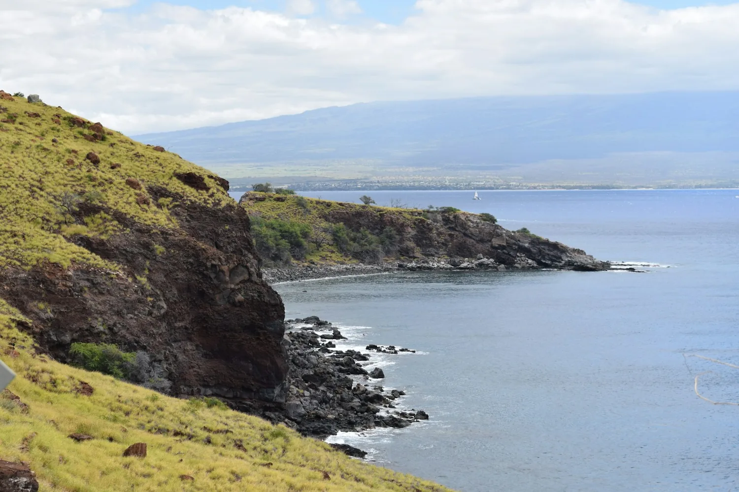 West Maui coastline with mountains rising behind the shore